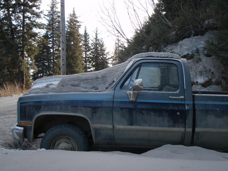 Vehicle covered in ash and snow